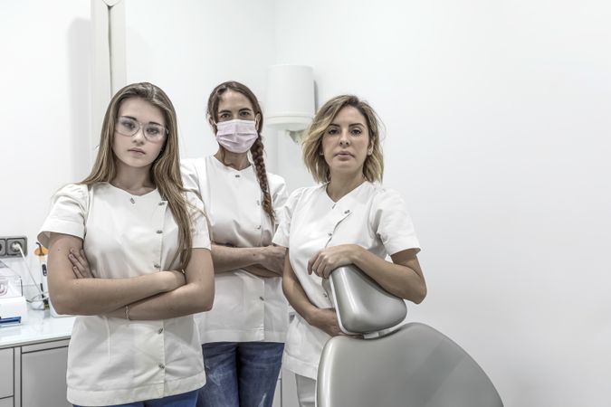 Group of a female dental staff in medical center standing near the chair