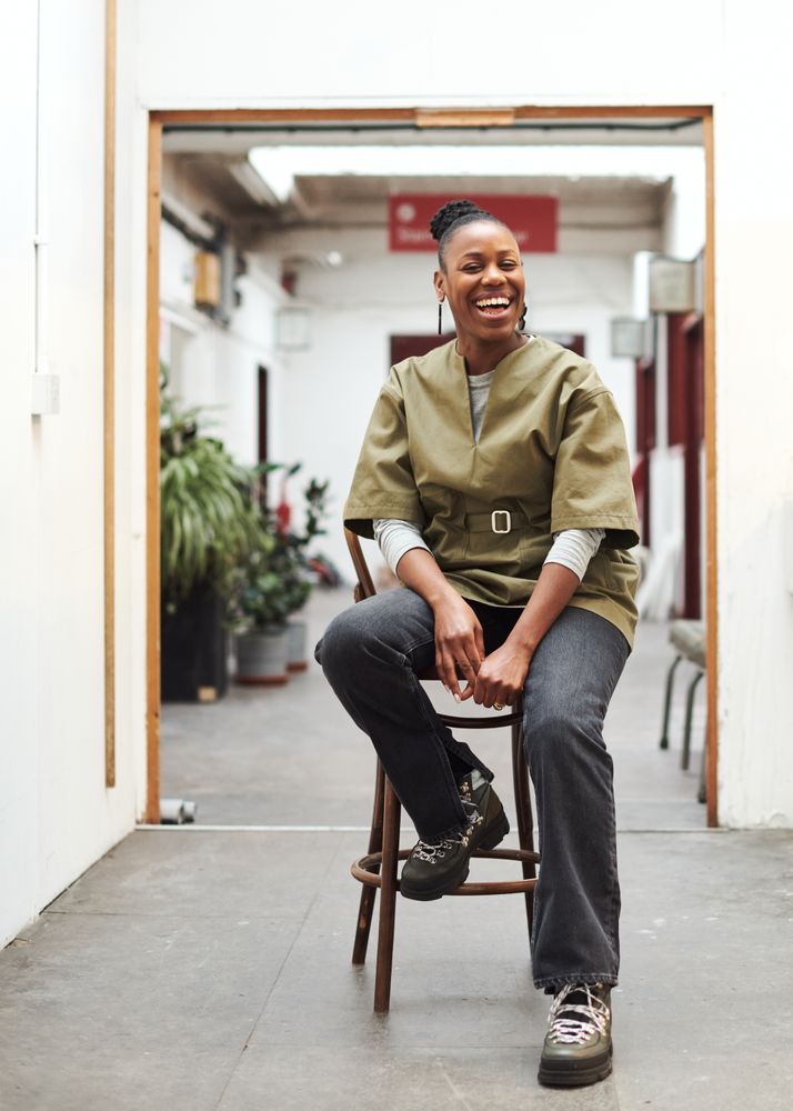 Woman smiling on stool in the hallway