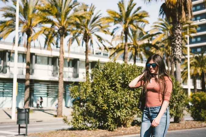 Teen girl walking happily through the streets of the city.