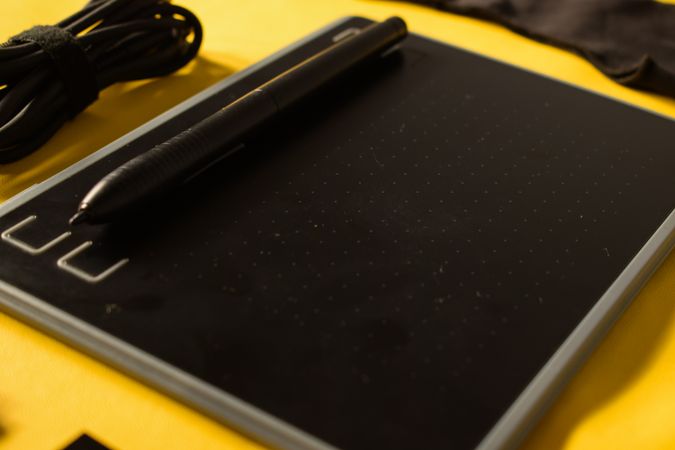 Close up of digital tablet on yellow background