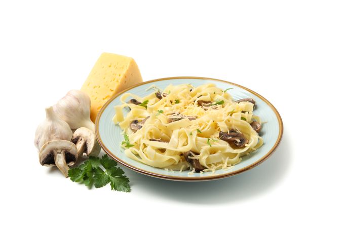 Plate with pasta, cheese and mushrooms isolated on plain background