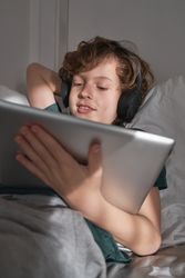 Happy child watching video on tablet
