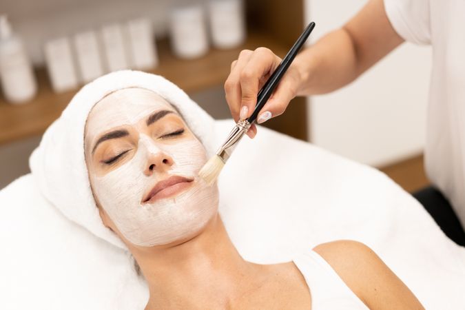 Female having a face mask professionally applied