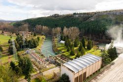 Contemporary hydroelectric power station in landscape