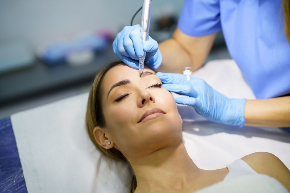 Permanent make-up on eyebrows of beautiful woman in a beauty salon