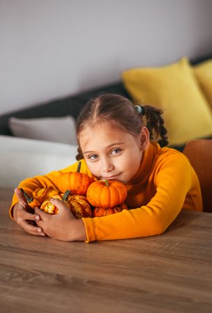 Little Girl Playing With a Pumpkin.