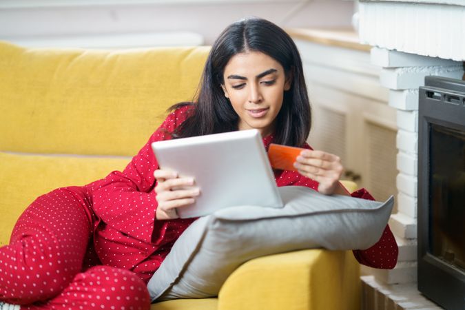 Female shopping at home on tablet with credit card