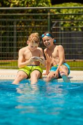 Boys on poolside taking selfie