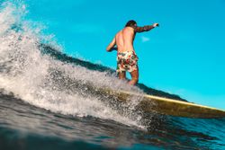 Man on surf board on waving water