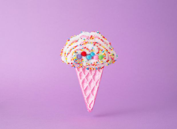 Cute ice cream cone toy on purple background