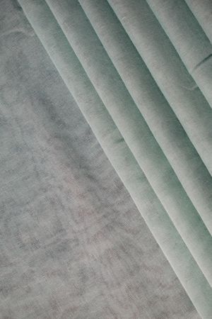 Nude green fabric folded background texture