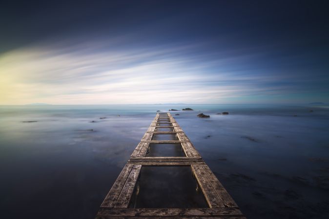 Wooden pier remains in a blue sea