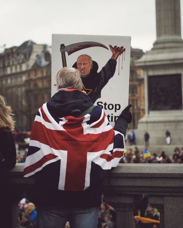 London, England, United Kingdom - March 5 2022: Man draped in Union Jack at anti-war protest