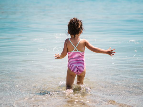 Cheerful girl having fun in warm sea