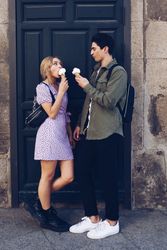 Happy couple feeding each other by ice cream