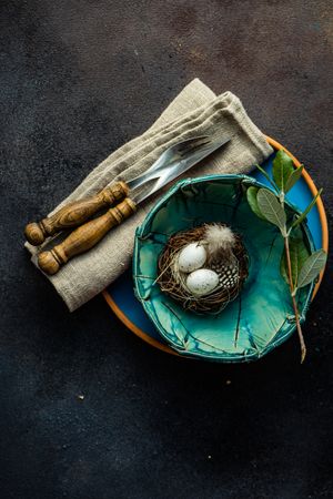 Easter table setting with nest in teal bowl