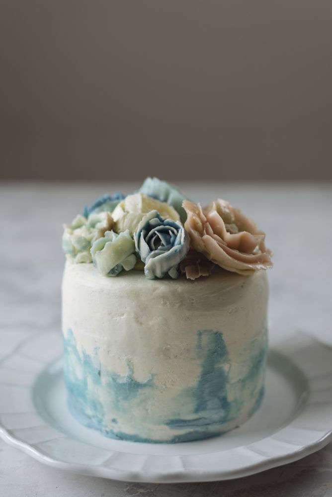Buttercream flowers cake, blue and pastel peach colors