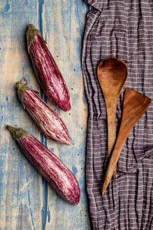 Ripe eggplants on shabby tabletop