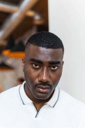 Serious Black man in eyeglasses on white background