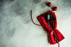 Christmas cutlery set in red on concrete