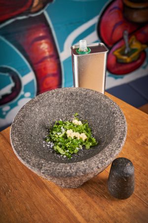Greens in mortar on table