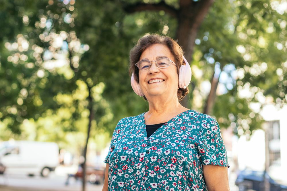 Mature woman walking down the street listening to music