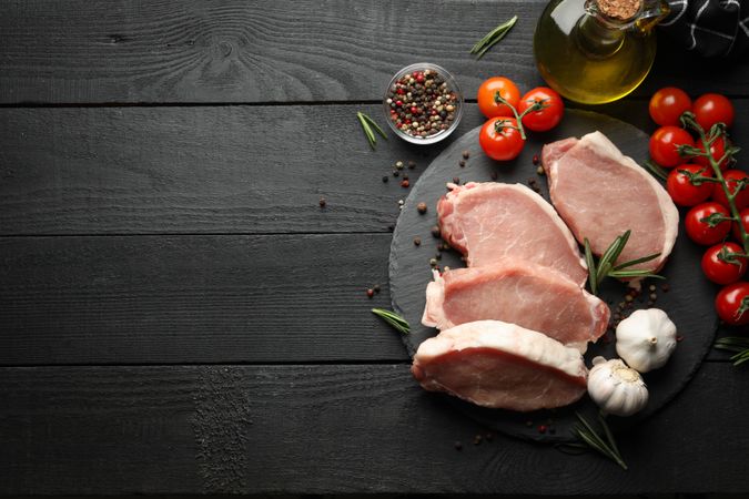 Composition with raw meat for steak and ingredients on wooden background
