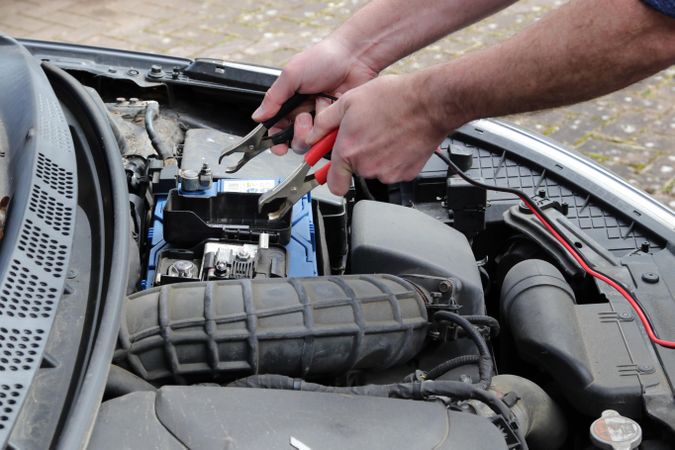 Mechanic fixing car's engine outdoor