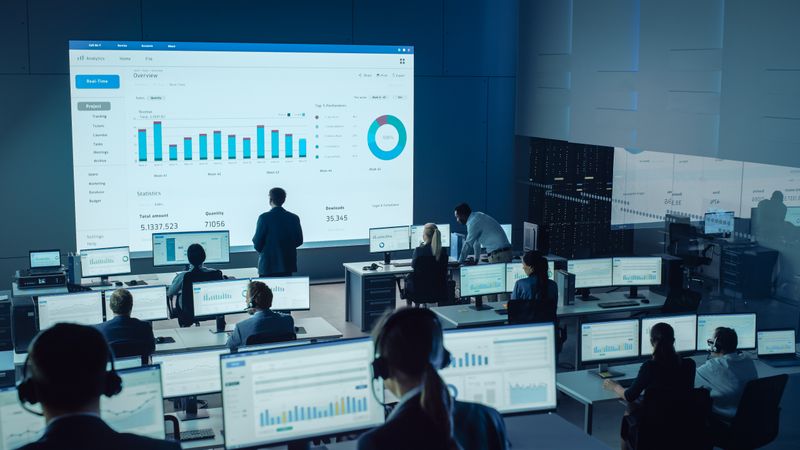 Data Analysts Monitor Real-time Statistics in a High-tech Operations Center.