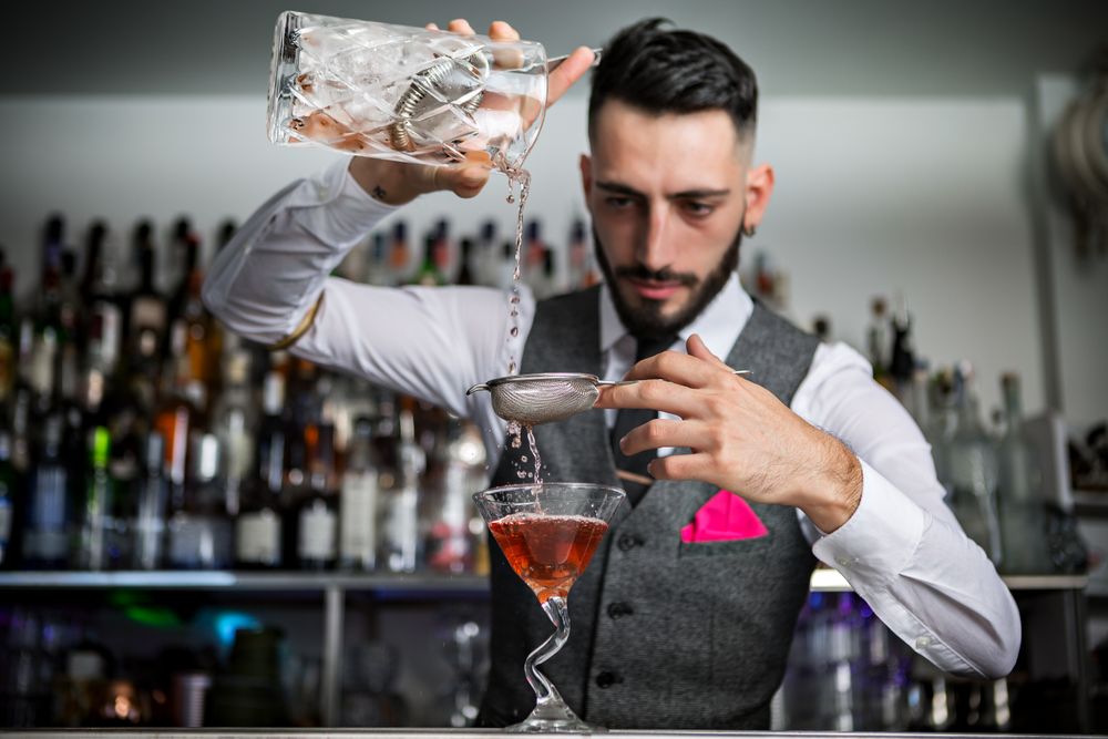 Bartender using double straining technique
