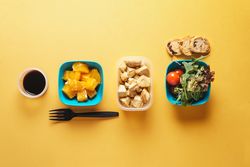 Plastic containers with healthy food and fork