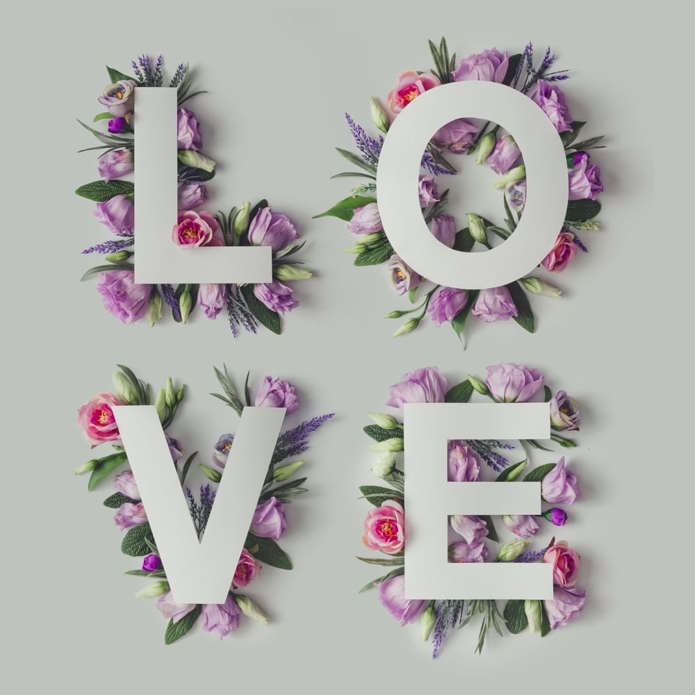 Layout with colorful flowers, leaves and word LOVE