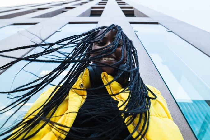Black woman against skyscraper in city
