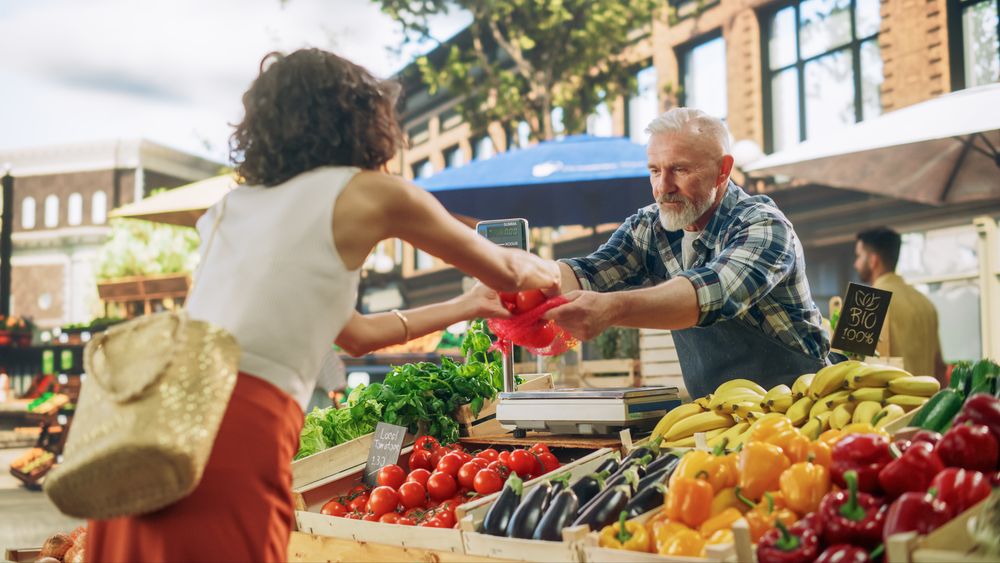 Female Buying Bio Tomatoes and Ecological Local Garlic From a Happy Senior Street Vendor
