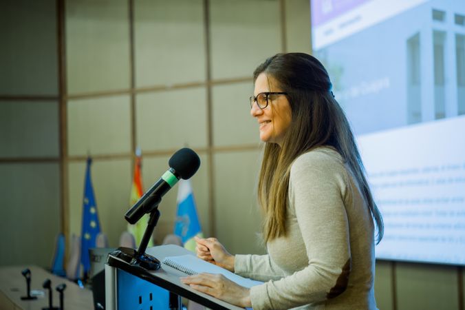 Smiling woman giving lecture in university