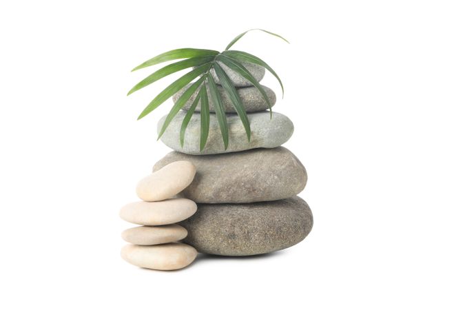 Stones and tropical leaf, isolated on plain background