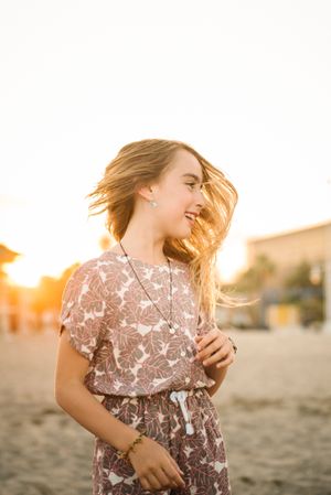 Laughing girl in sunset on beach