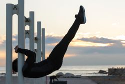 Sportsman performing exercise on crossbar