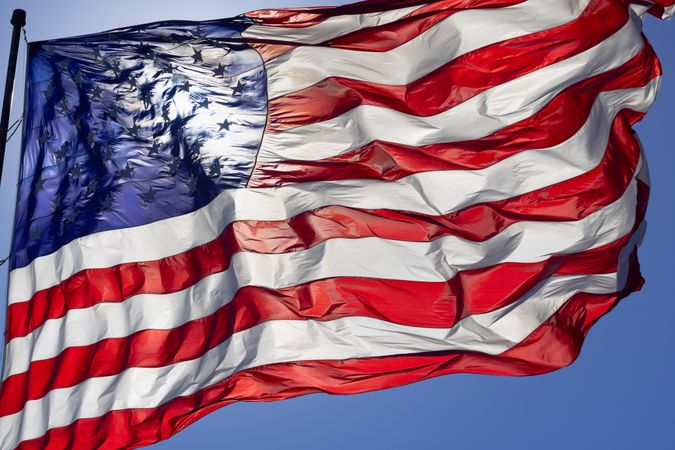Dramatic Backlit American Flag Waving in the Wind.