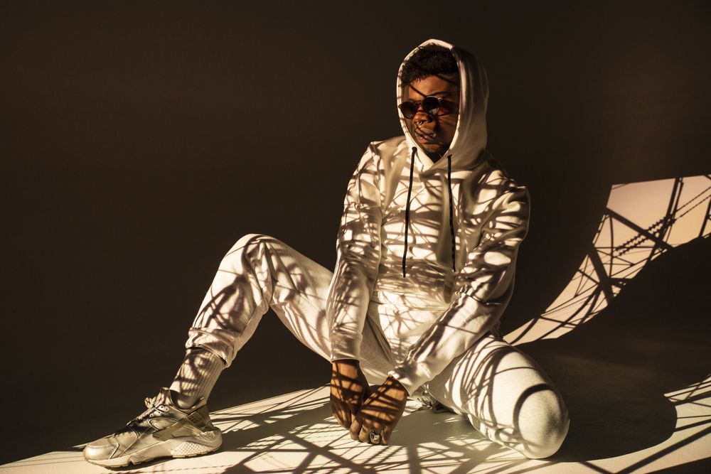Black man dancing under bright light