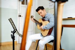Man playing guitar in studio