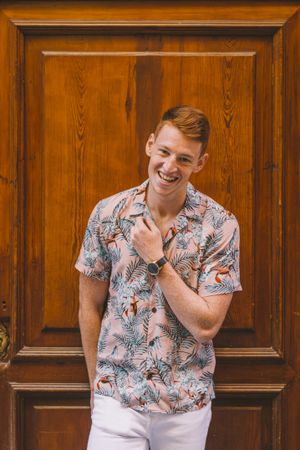 Man leaning on wooden door