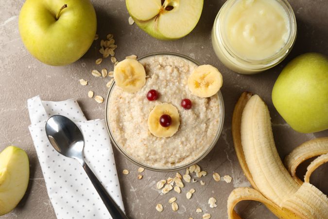 Composition with baby food on gray background, top view