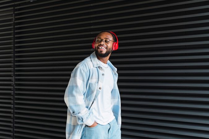 Smiling Black man in headphones and jacket