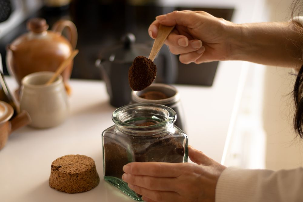 woman making coffee in an italian coffee maker in a kitchen.