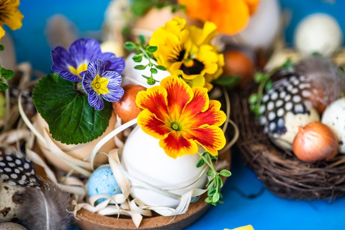 Close up of Easter holiday card concept with cute bird's nest on bright blue table