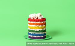 Rainbow cake isolated on a green background bG2Zv4