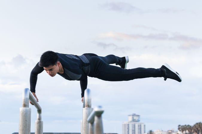 Athlete doing exercise on parallel bars