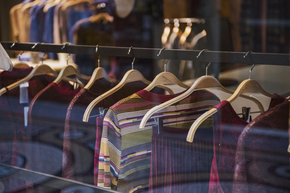 Clothes rack of selected red outfits in fashion store