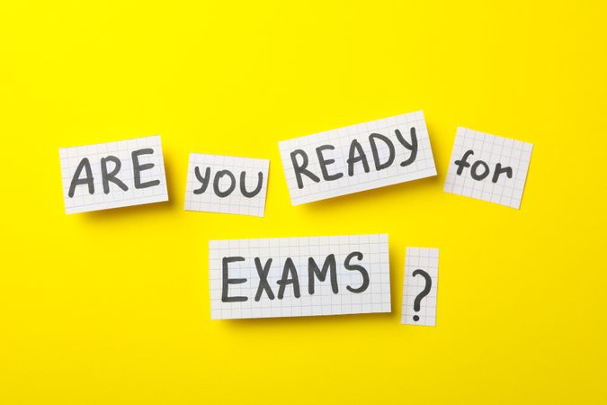Flat lay of “are you ready for exams” on yellow table